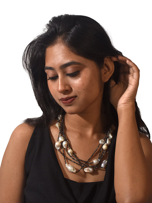 layered pearl necklace with silver and gold-colored beads