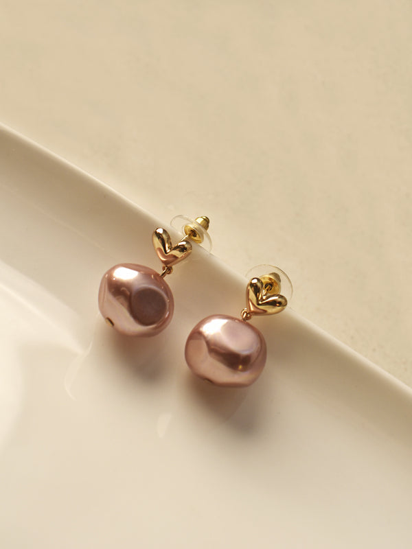 stud earrings with large, lustrous pinkish-gold baroque pearls,